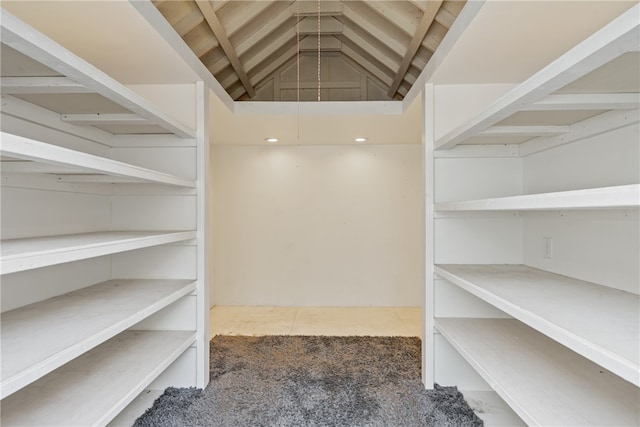 spacious closet featuring lofted ceiling and tile flooring