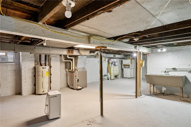 basement featuring heating utilities, sink, brick wall, and electric water heater