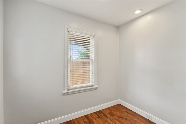 empty room with dark wood-type flooring