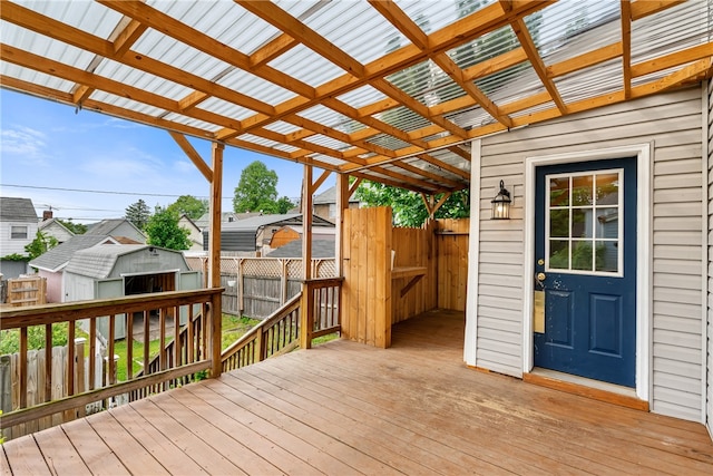 wooden terrace with a storage shed