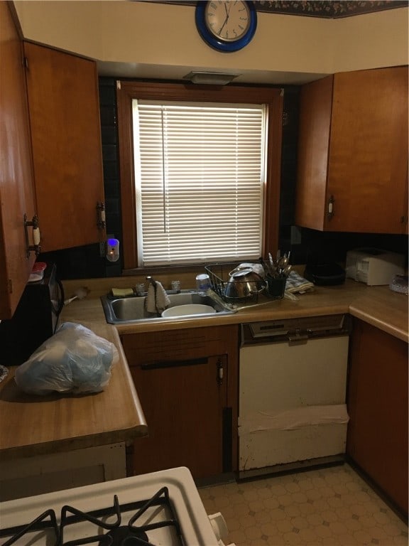 kitchen featuring sink and light tile floors