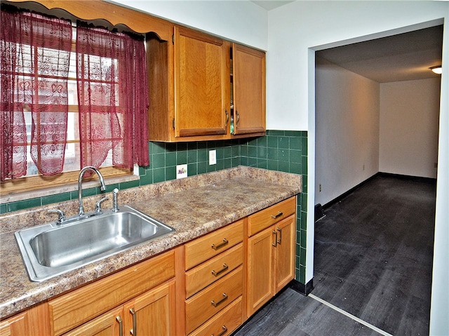 kitchen featuring backsplash, dark hardwood / wood-style floors, and sink