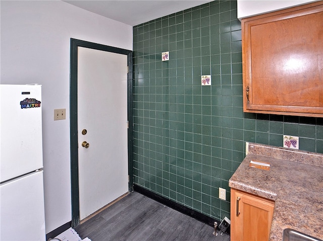 bathroom featuring tile walls and hardwood / wood-style floors