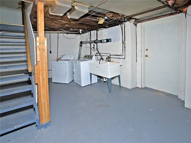 basement featuring independent washer and dryer and sink