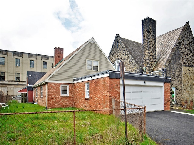 view of home's exterior with a yard and a garage