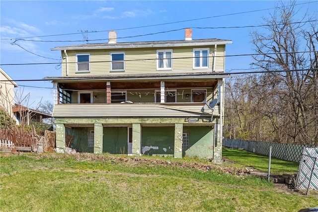 back of house with a lawn