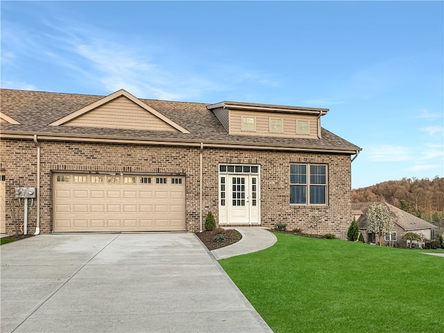 view of front of home with a garage and a front lawn