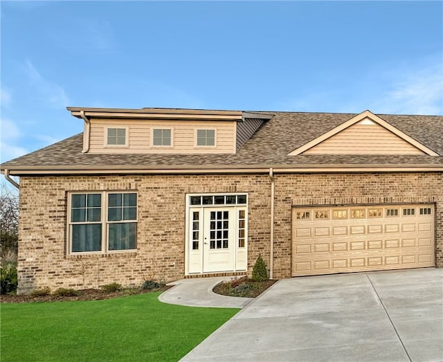 view of front of house with a garage and a front yard