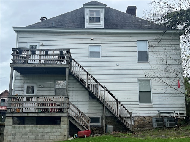 back of house featuring central AC