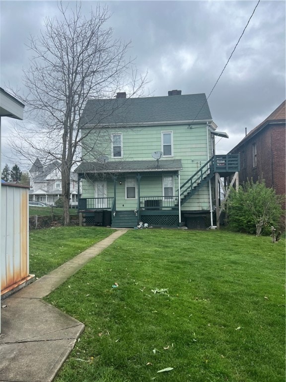 rear view of house with a lawn