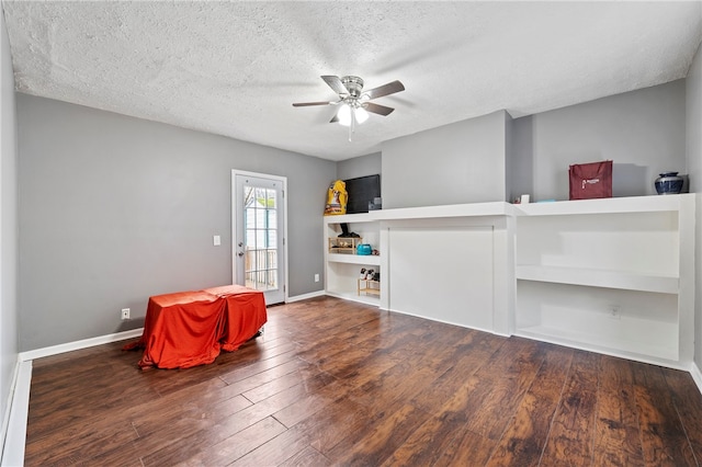 interior space with dark hardwood / wood-style floors, a textured ceiling, and ceiling fan