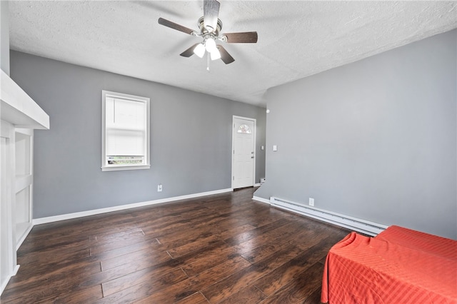 unfurnished room with dark hardwood / wood-style flooring, ceiling fan, a baseboard radiator, and a textured ceiling