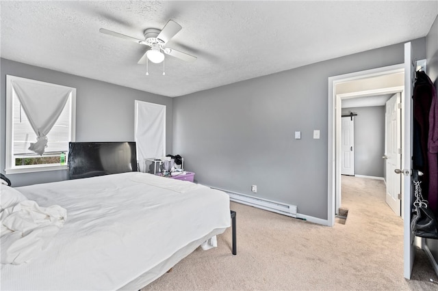 bedroom with ceiling fan, light colored carpet, a baseboard heating unit, and a textured ceiling