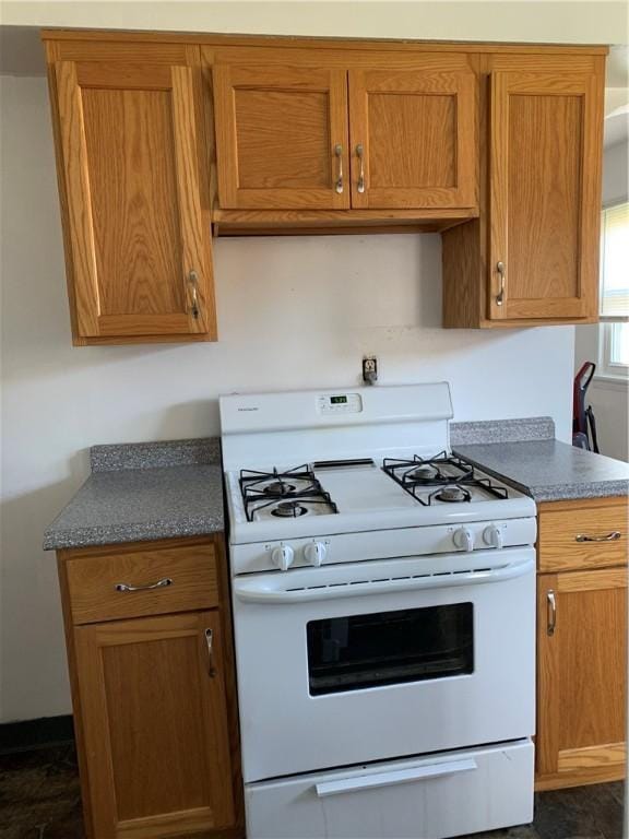 kitchen featuring white range with gas cooktop