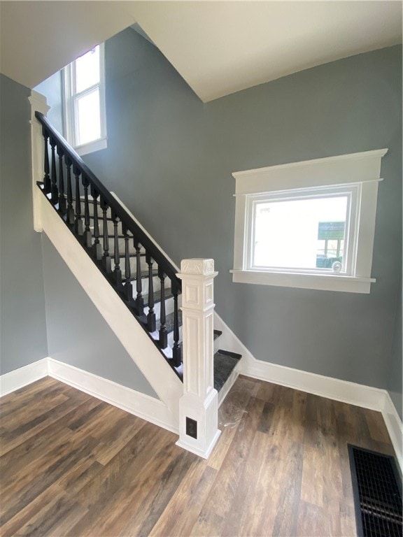 stairway with dark wood-type flooring