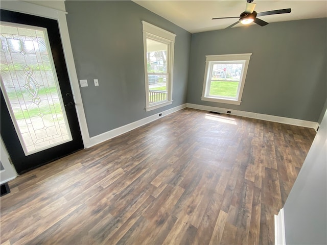 spare room with ceiling fan and dark hardwood / wood-style flooring