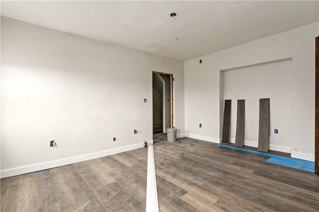 unfurnished room featuring dark wood-type flooring