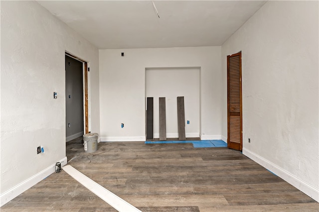 spare room featuring dark hardwood / wood-style flooring