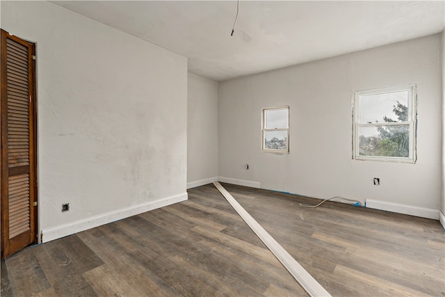 unfurnished room featuring dark hardwood / wood-style floors