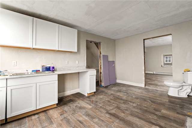 kitchen featuring baseboard heating, dark wood-type flooring, and white cabinetry