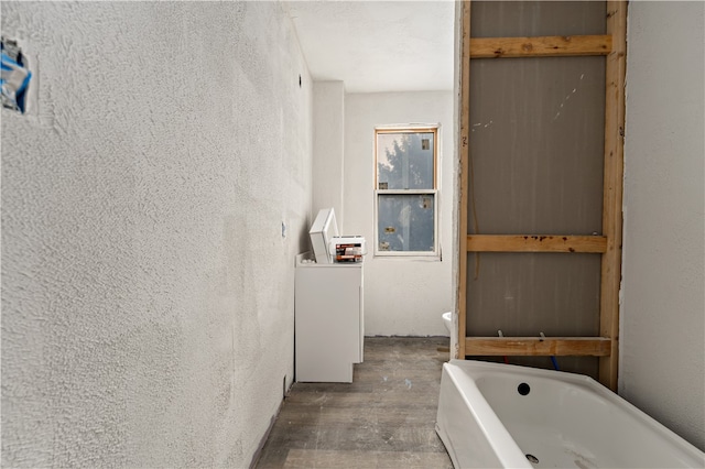 bathroom featuring hardwood / wood-style floors and a bath