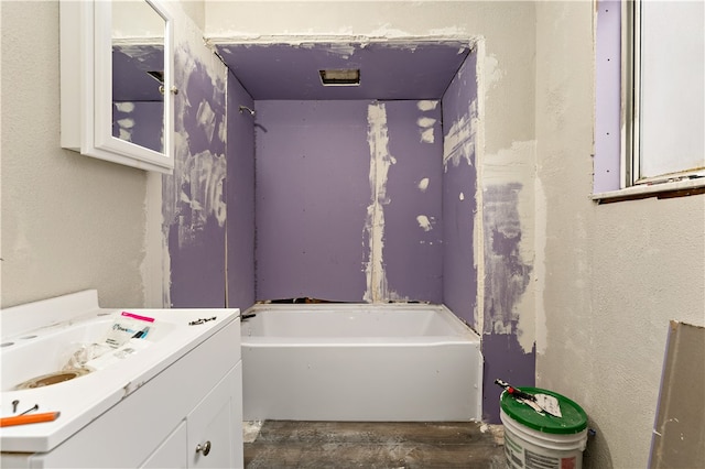 bathroom featuring a bath and oversized vanity