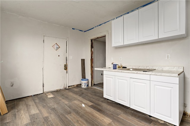 kitchen with dark wood-type flooring and white cabinetry