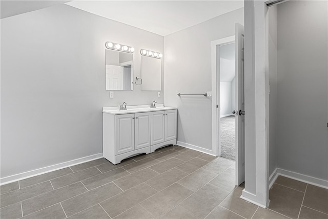 bathroom featuring double sink, tile floors, and vanity with extensive cabinet space