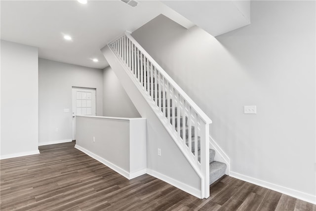 staircase featuring dark wood-type flooring