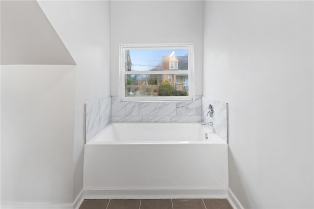 bathroom featuring tile floors and a bathtub