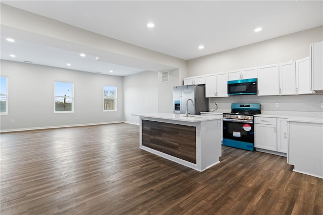 kitchen featuring stainless steel fridge, white cabinets, electric range oven, and dark hardwood / wood-style flooring