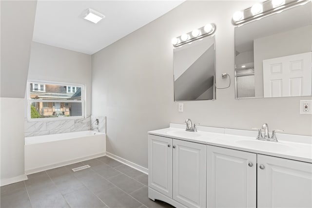 bathroom with a bath to relax in, tile floors, and dual bowl vanity