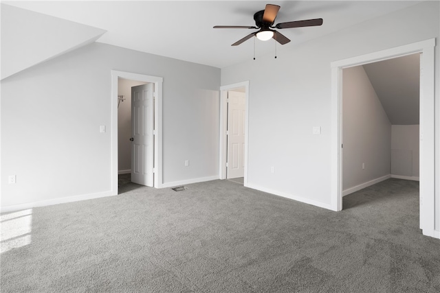 carpeted empty room with ceiling fan and vaulted ceiling