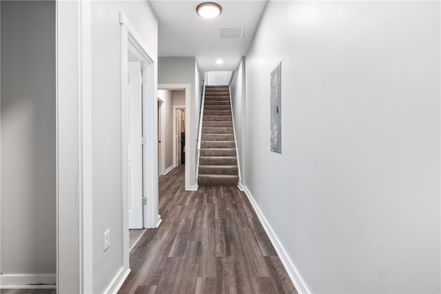 corridor with dark hardwood / wood-style flooring