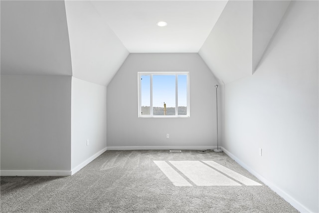 additional living space with light carpet and lofted ceiling