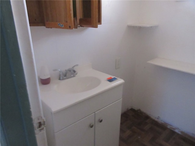 bathroom featuring parquet flooring and vanity