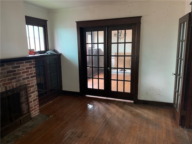 unfurnished living room with dark hardwood / wood-style flooring, french doors, and a fireplace