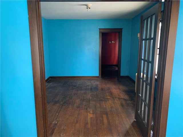 corridor with dark hardwood / wood-style flooring