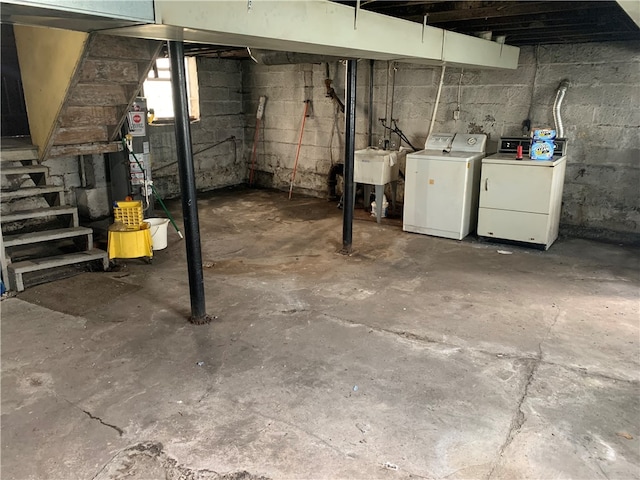 basement with sink and washer and dryer