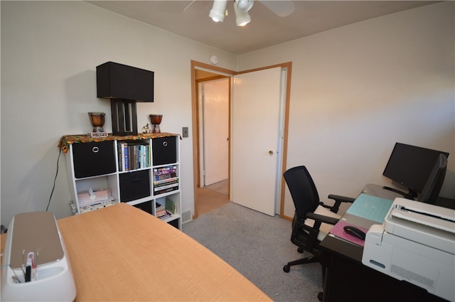 carpeted home office featuring ceiling fan