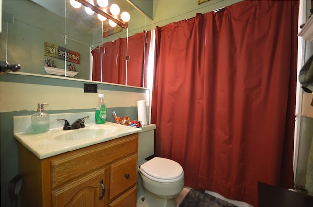 bathroom featuring walk in shower, vanity, and toilet