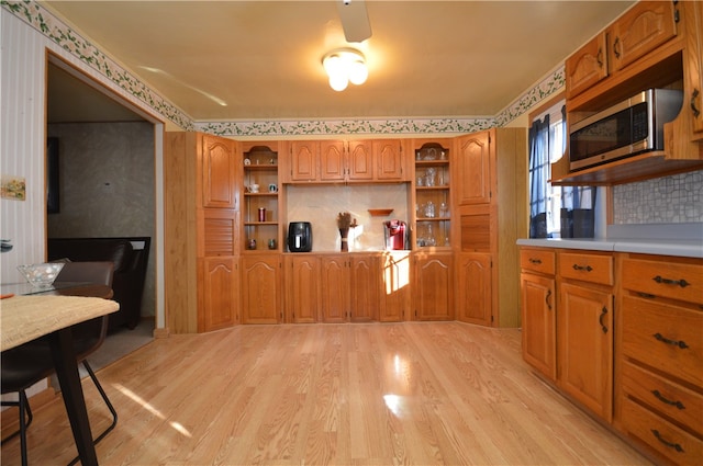 kitchen featuring light wood-type flooring and backsplash