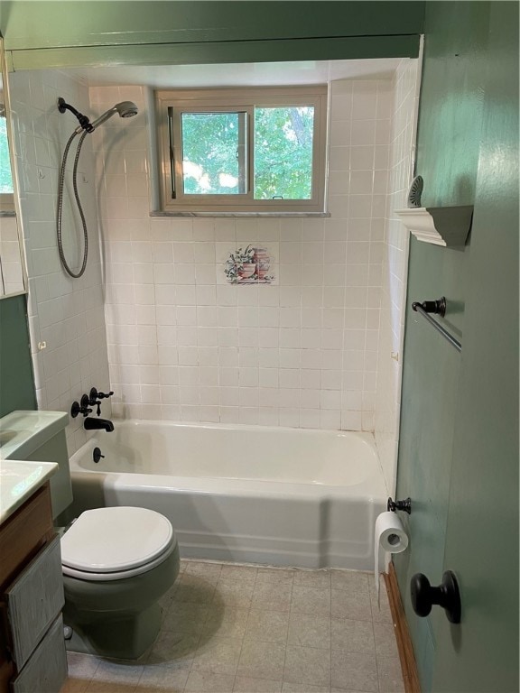 full bathroom with tiled shower / bath combo, vanity, and toilet