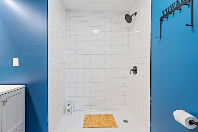 bathroom featuring vanity and tiled shower