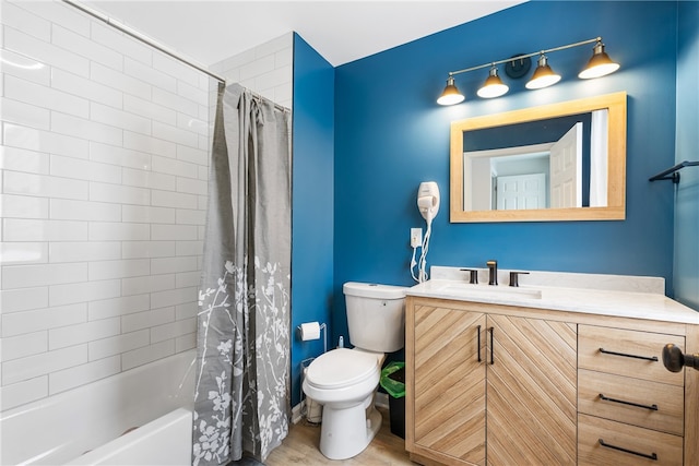 full bathroom with shower / tub combo, wood-type flooring, vanity, and toilet