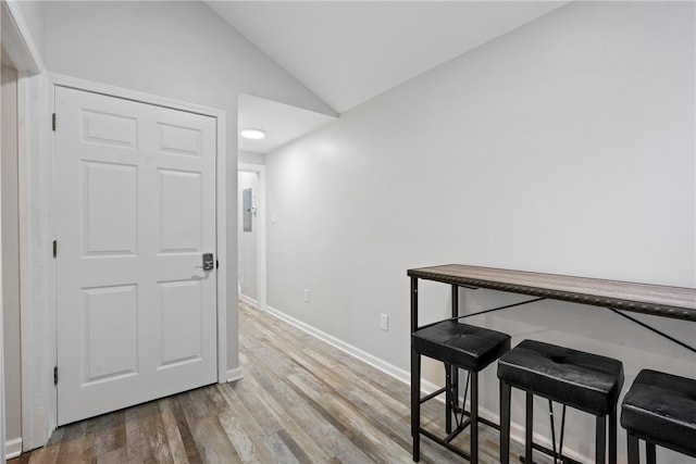 dining area featuring light hardwood / wood-style flooring and lofted ceiling