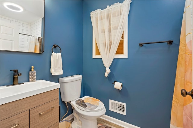 bathroom featuring vanity and toilet