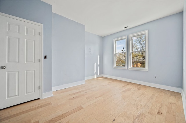 spare room with light hardwood / wood-style floors