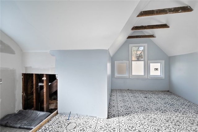 bonus room featuring lofted ceiling with beams and tile flooring