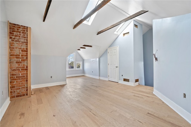 bonus room with brick wall, light hardwood / wood-style floors, and vaulted ceiling with skylight